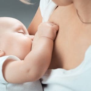 mother breastfeeding after breast implants in san diego