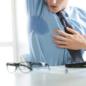 man excessively sweating under armpits