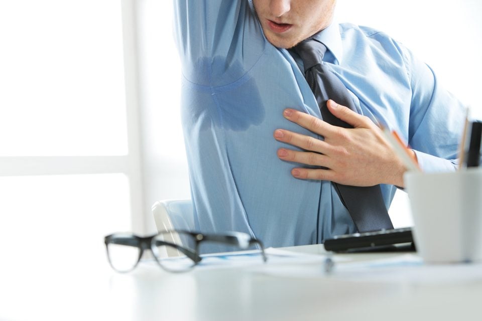 man excessively sweating under armpits