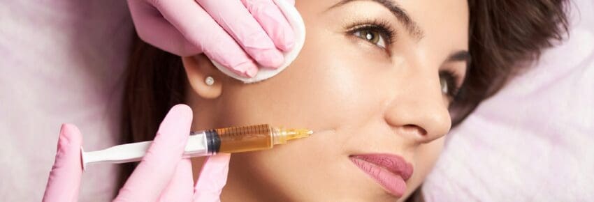 Close-up of beautiful woman getting injection in the cosmetology salon.