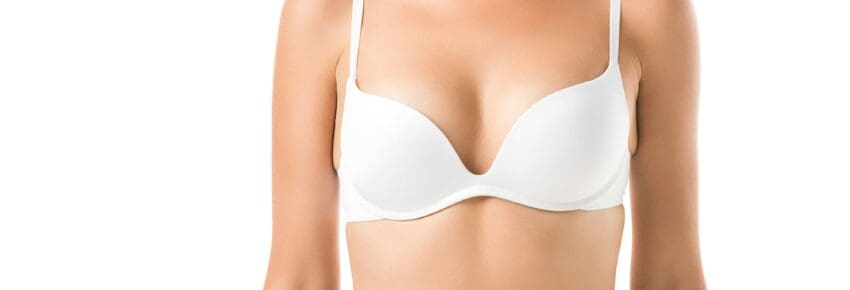 cropped shot of young woman in bra isolated on white