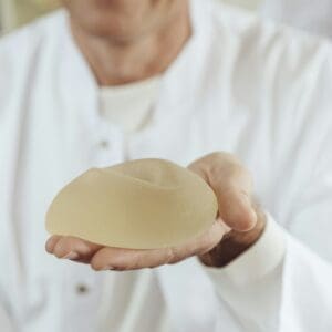 Doctor showing a silicone breast implant