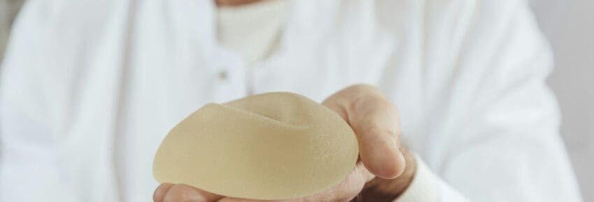 Doctor showing a silicone breast implant