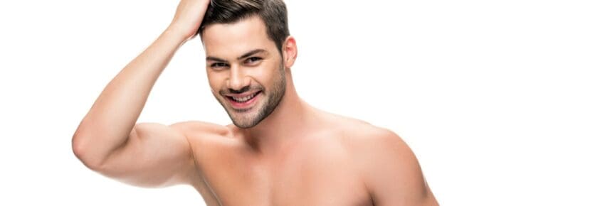 handsome shirtless man touching his hair isolated on white