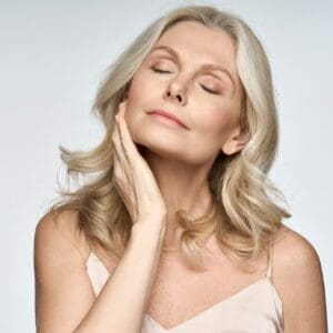 Skin care ads portrait of beautiful 50 years old woman isolated on white.