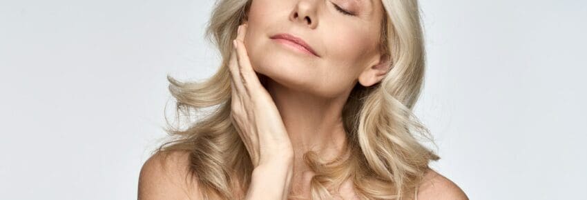 Skin care ads portrait of beautiful 50 years old woman isolated on white.