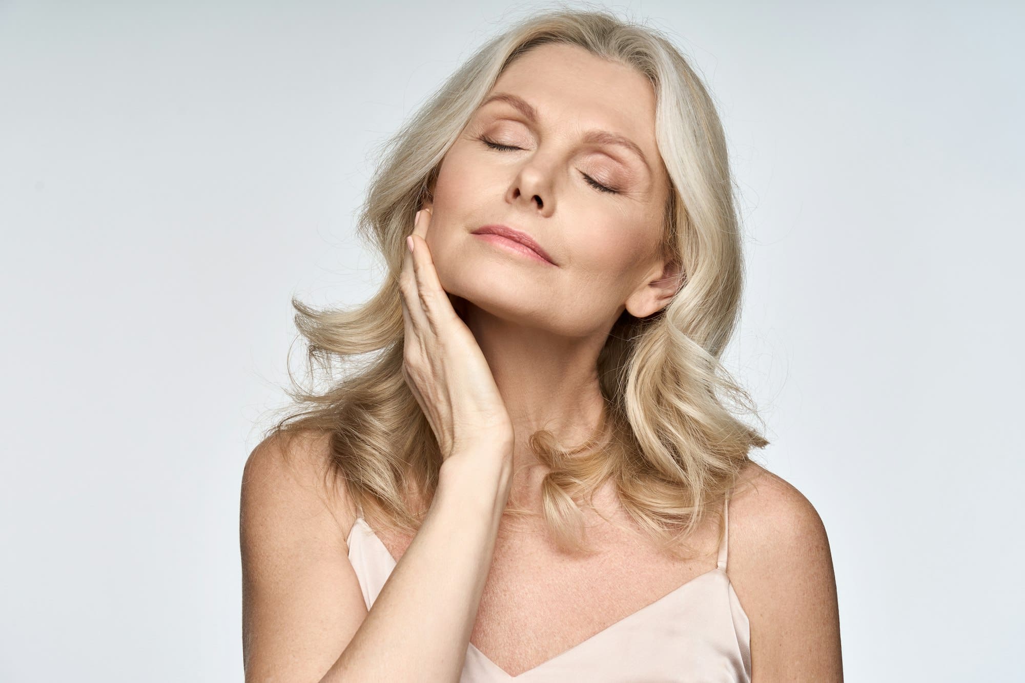 Skin care ads portrait of beautiful 50 years old woman isolated on white.
