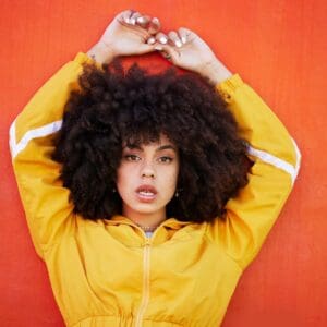 Portrait, fierce and black woman with attitude, power and empowerment with afro on studio backgroun