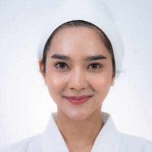 young Asian woman making treatment cosmetic beauty therapy on a face at cosmetological clinic